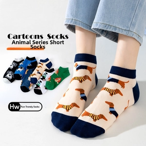 Detail of low-cut cotton socks featuring diverse cartoon animal patterns for men