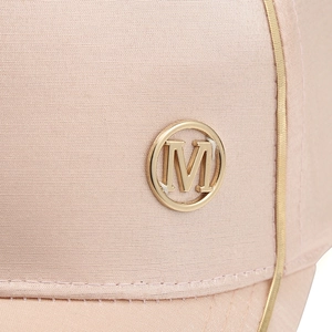 Close-up of pink satin baseball cap featuring a golden M logo and metallic piping detail