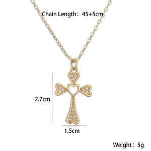 Detail shot of heart cross pendant with dimensions 2.7cm by 1.5cm in gold finish