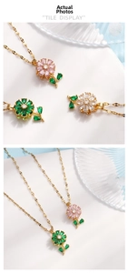 Macro detail of rotating flower pendants with pink and green zircon in gold plating