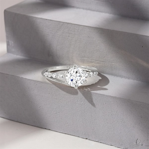 Macro detail of S925 sterling silver ring with large round solitaire diamond on stone base