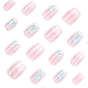 Blue floral press-on nails with pink gradient, white pearls and silver glitter accents