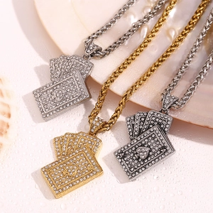 Macro shot of 18K gold and silver playing card pendants with sparkling crystals