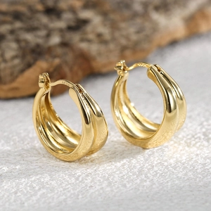 Elegant gold-plated striped wavy hoop earrings for women with polished metal texture