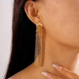 Close-up of golden long multi-strand chain tassel earrings on model with metal finish