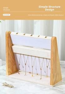 Macro detail of wooden jewelry stand with cream velvet tiers for necklaces