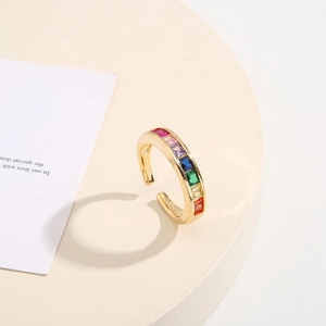 Minimalist gold adjustable ring with geometric multi-color zircon stones on white stand