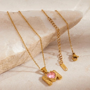 Detail of pink heart zircon pendant on 18K gold-plated O-chain over marble