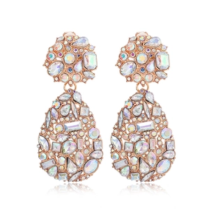 Detail of rose gold teardrop earrings featuring crystal rhinestones on a white background