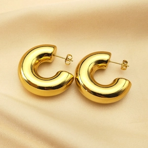 Polished chunky gold-tone C-shaped hoop earrings with a sleek minimalist metallic finish