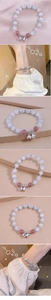 Close-up of beaded bracelet with white opal stones and silver bells on pink satin