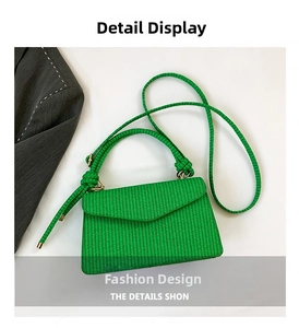 Top view of vibrant green woven envelope bag with thick rope handle and golden hardware