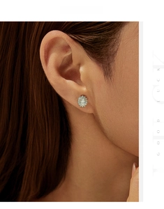 Macro shot of a floral S925 sterling silver stud earring with sparkling moissanite stones