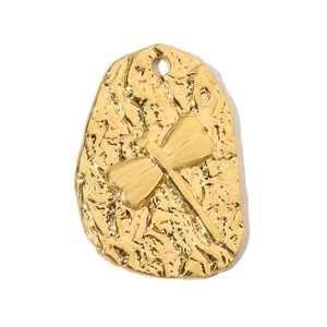 Detailed view of a golden hammered metal pendant with a 3D dragonfly relief motif