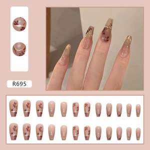 Dark red coffin press-on nails with vintage leaf silhouettes and gold foil accents