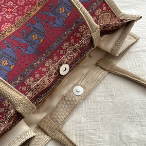 Ethnic style jute tote bag with blue elephant embroidery and magnetic metal closure