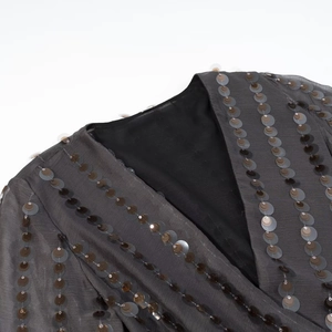 Women's V-neck sequined jumpsuit in charcoal grey featuring sheer fabric detail