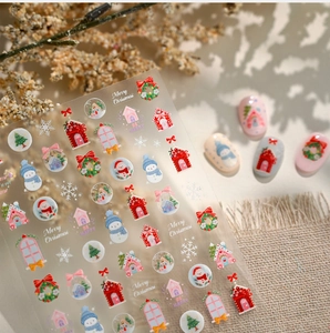 Vue détaillée des stickers à ongles de Noël avec motifs de bonhomme de neige et sapin