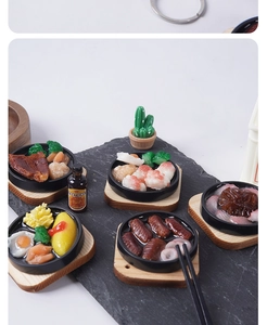 Detailed view of miniature resin teppanyaki food charms including steak and shrimp