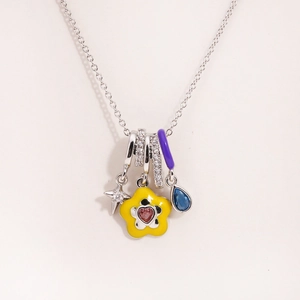 Detail of colorful enamel flower and gemstone pendants on a titanium steel necklace
