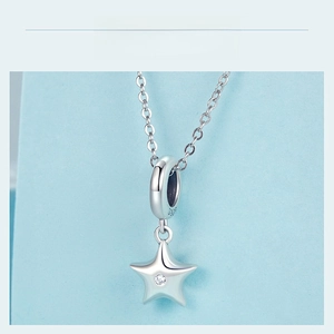 Macro shot of 925 sterling silver star pendant with cubic zirconia and S925 hallmark
