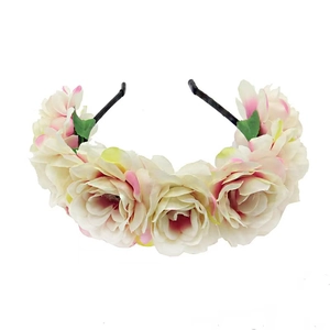 Close-up detail of realistic cream and pink fabric rose flowers on a floral headband