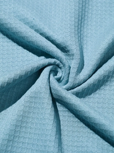 Close-up of the light blue waffle knit fabric texture and premium weaving detail