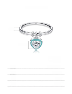 Macro shot of S925 sterling silver ring with blue enamel heart and zircon pendant