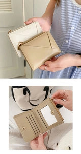 Detail of minimalist foldable wallet featuring multiple card slots and a gold zipper pocket