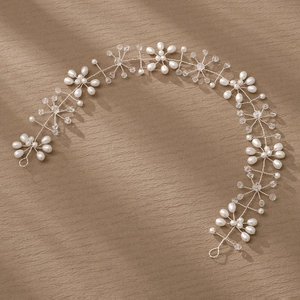 Detail of bridal hair vine with white pearls and crystal beads on silver wire