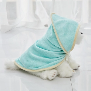 Detail of mint green hooded pet towel made of absorbent coral fleece on a white pomeranian
