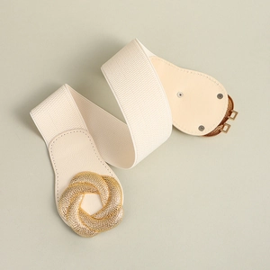 Cream elastic wide waist belt for women with golden spiral buckle on grey-green background