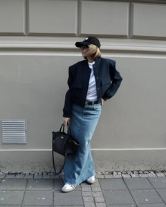 Dettaglio della giacca corta blu scuro con grandi tasche e gonna lunga in denim casual