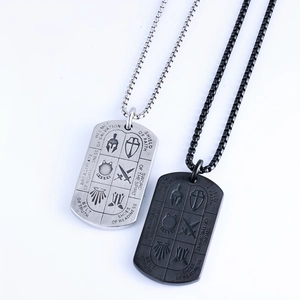 Detail of silver and black metal knight dog tag necklaces with symbolic engravings