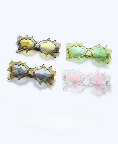 Detailed view of four irregular wavy star-shaped sunglasses in vibrant assorted colors