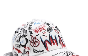 Close-up of white cotton baseball cap showing colorful street graffiti print and stitching