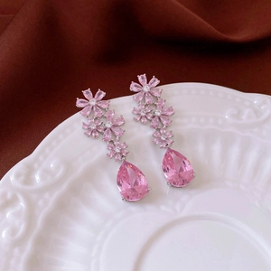 Detailed view of pink flower stud earrings with water drop crystals and diamond accents