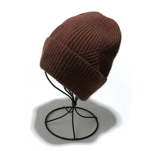 Detail of dark brown ribbed knit beanie with turn-up cuff on a professional stand