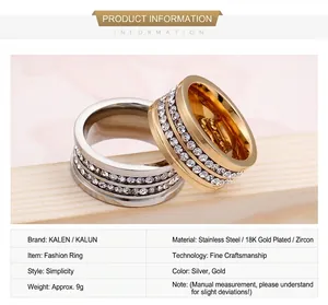 Detail view of steel and gold titanium rings with double-row rhinestones and engravings