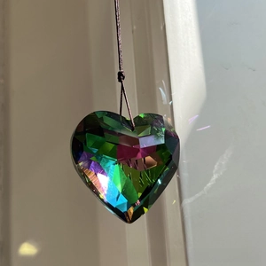 Detail of multi-faceted 45mm crystal heart prism with vibrant iridescent rainbow light effects