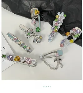 Detailed view of silver bow hair clips set with colorful crystals and heart charms