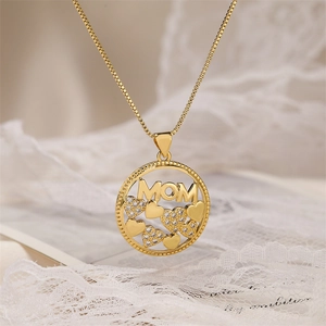Close-up of golden MOM pendant with heart motifs and sparkling zircons for women