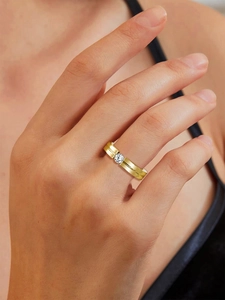 Close-up of a 4mm gold titanium steel ring with a sparkling inset cubic zirconia diamond