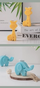 Close-up of yellow giraffe and blue elephant shaped scented candles on a textured background
