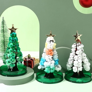 Three colorful magic crystal growing Christmas tree kits with glittery gold stars