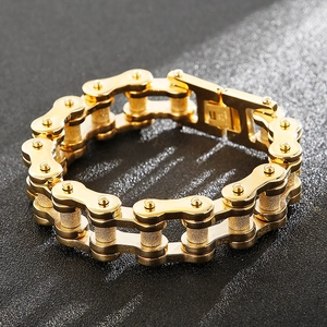 Detail of gold-colored stainless steel motorcycle chain bracelet with folding clasp