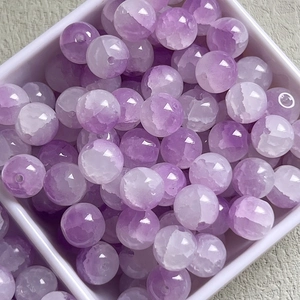 Macro view of 10mm purple cracked glass beads for DIY bracelet and necklace jewelry making
