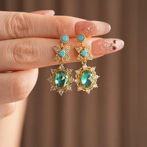 Détails de boucles d'oreilles vintage avec fleur en zircon bleu et pierres vertes
