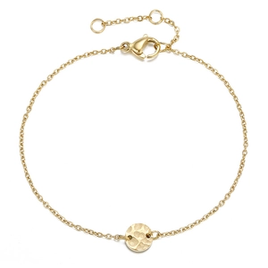 Macro shot of gold-plated cross chain with hammered round pendant and lobster clasp
