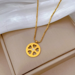 Macro shot of gold-plated titanium necklace featuring a hollow heart-shaped floral pendant